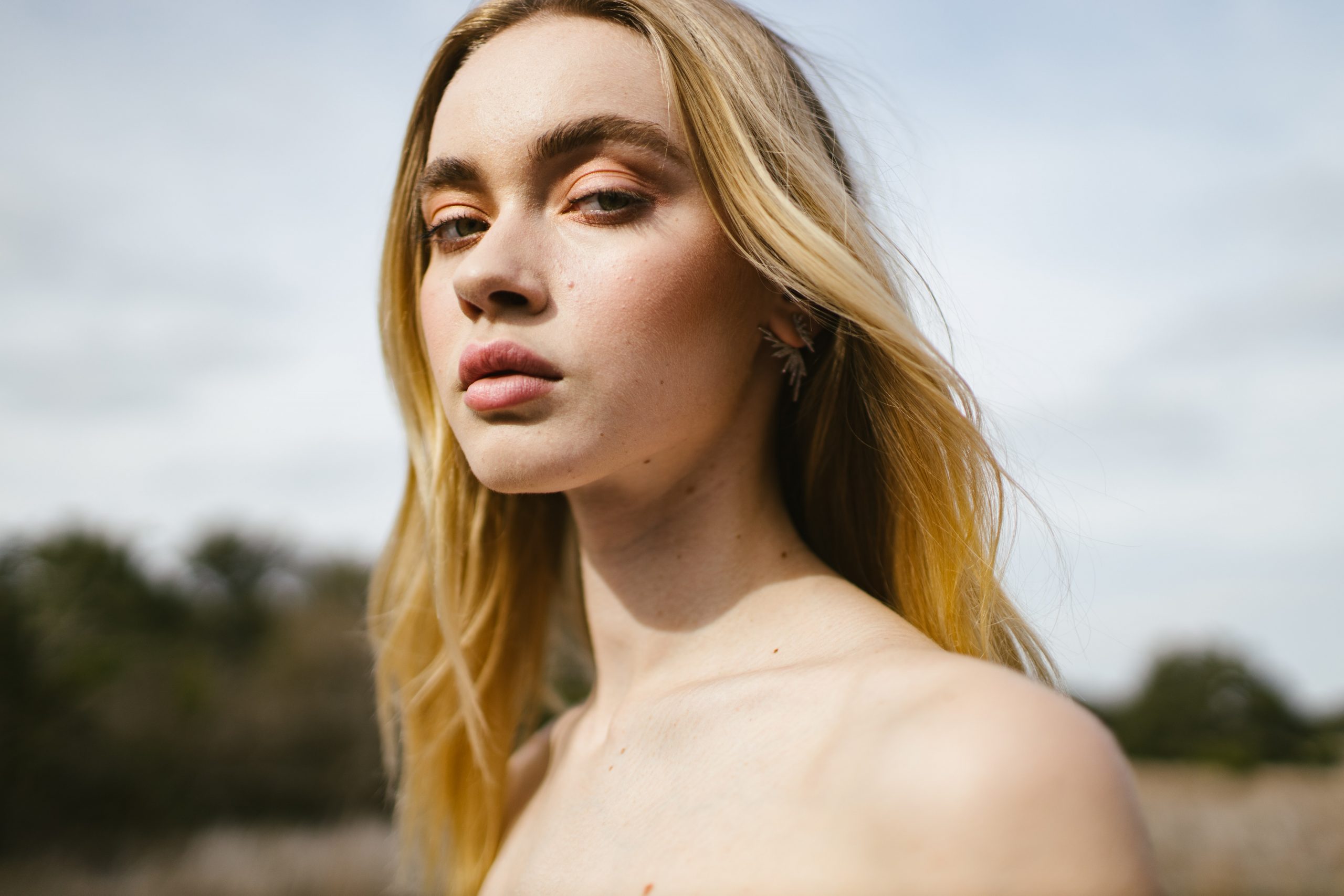 blonde woman influencer looking at the camera