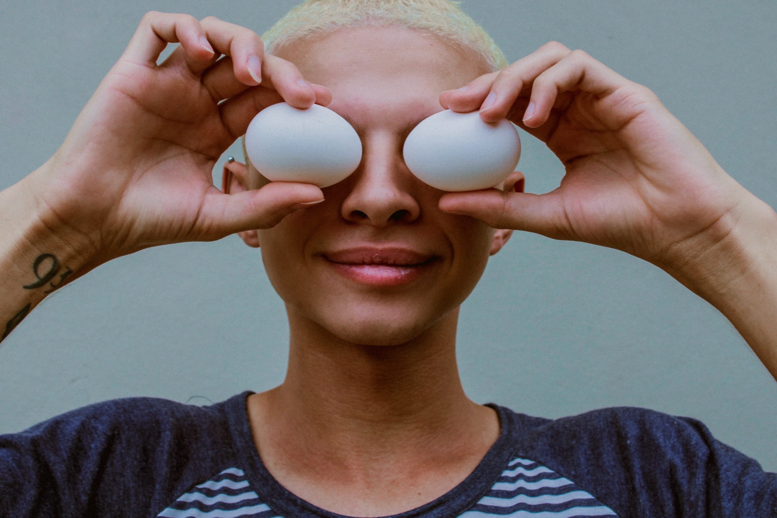woman holding two white eggs